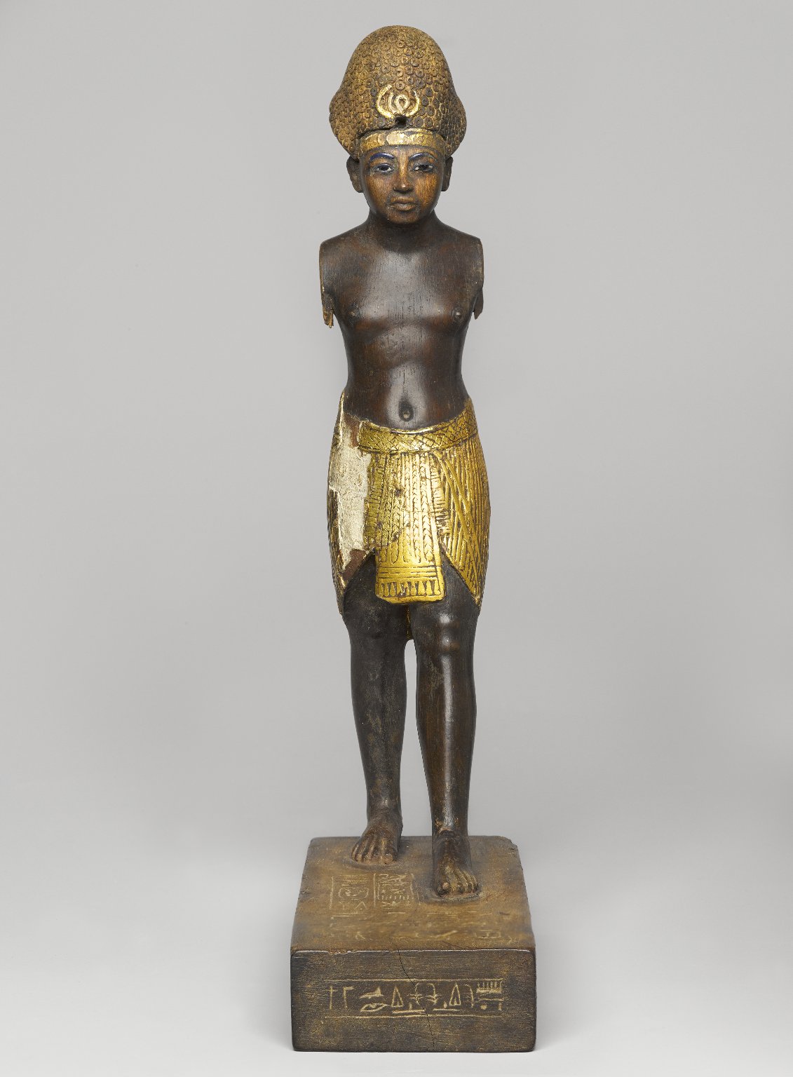 Cropped detail of Amunhotep III's head and complete patterned Blue Crown, with gold leaf and glass-inlaid eyes.