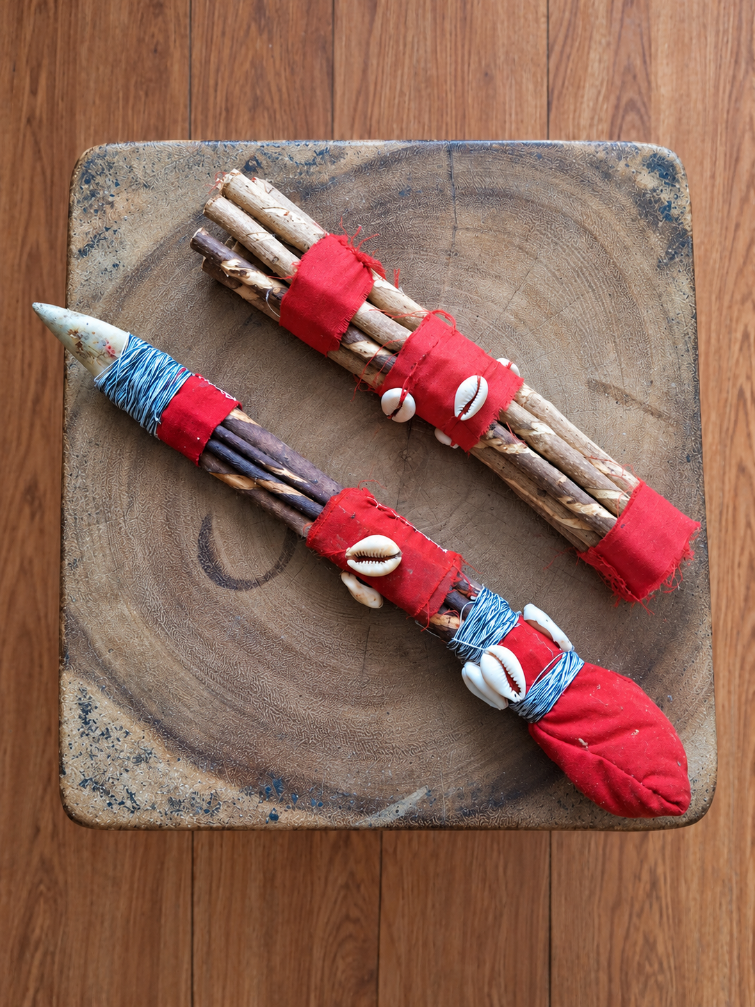 AI-assisted comparison illustration: basic traditional Isan above a reinforced warrior ancestral bundle with a buffalo-bone arrow tip representing Oya.